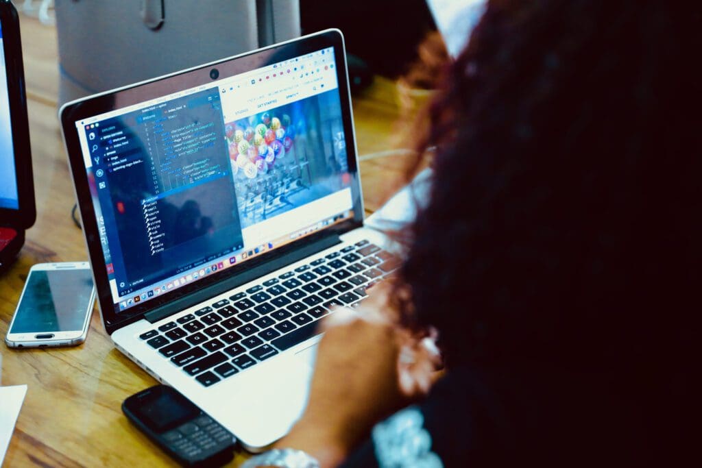 View of a black woman working on a laptop