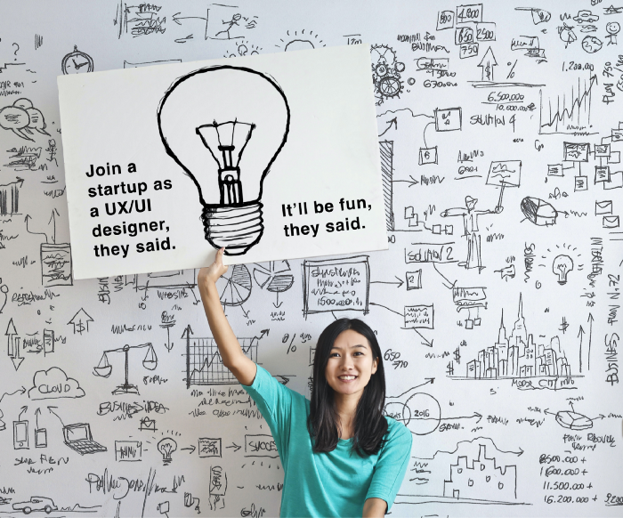 Asian woman holding a sign picturing a light bulb, UX/UI Designer