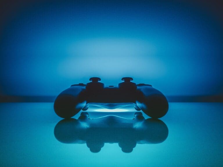 Photo of Microsoft Xbox controller taken in a blue light room, video games