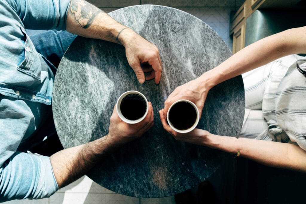 Couple of people holding mugs of coffee, meeting in a coffee shop, futureproof your career