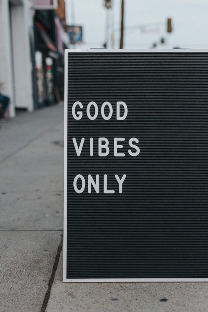 Good vibes only spelt out on a board on the street
