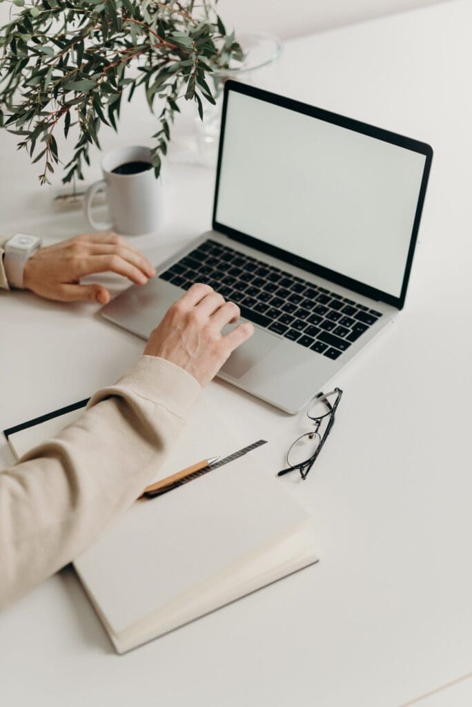 Man typing on a laptop with a blank screen, work reform