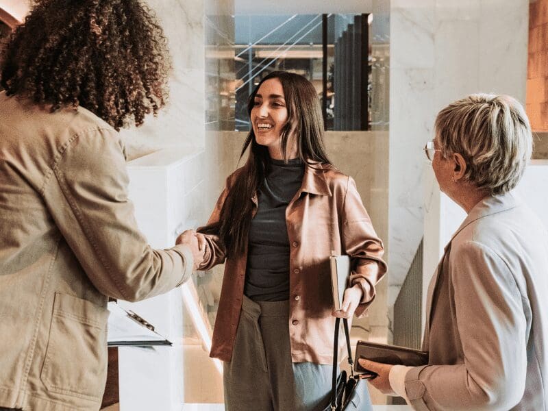 Woman shaking hands with inclusive employer, job search concept