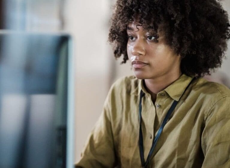 Black Woman Working in IT, Focused on Work in Office