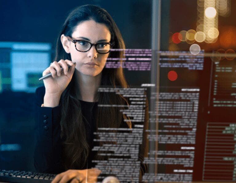 Female data scientist looking at data on a computer in an office