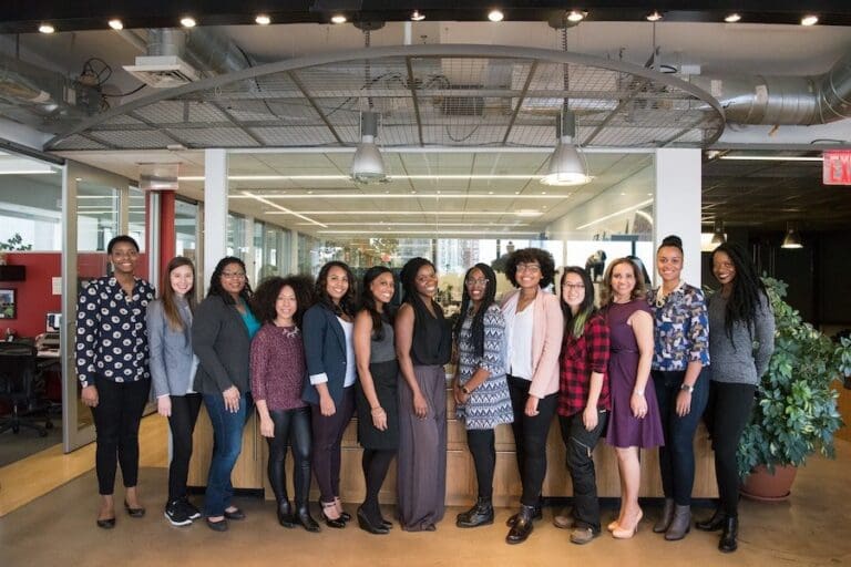 Group of Diverse Women in Tech Standing Near Desk, Female Tech Workforce