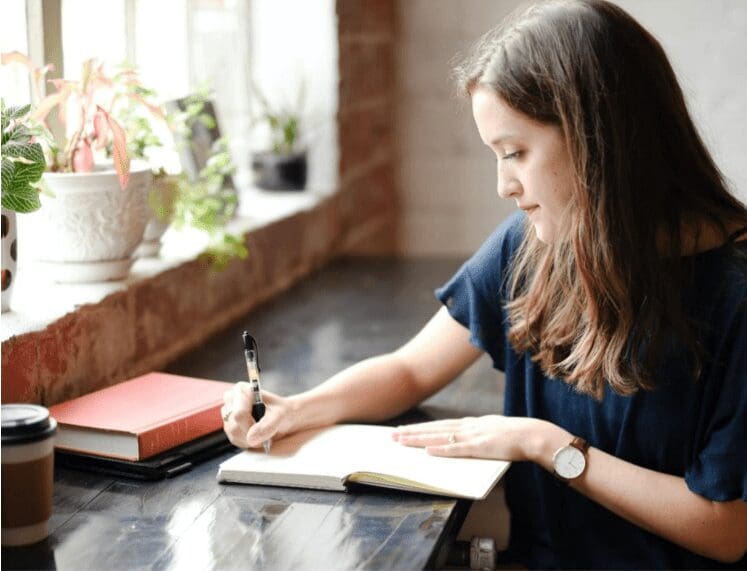 Woman writing in her journal
