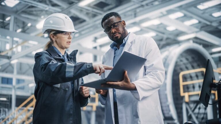 Woman engineer discusses information on a laptop