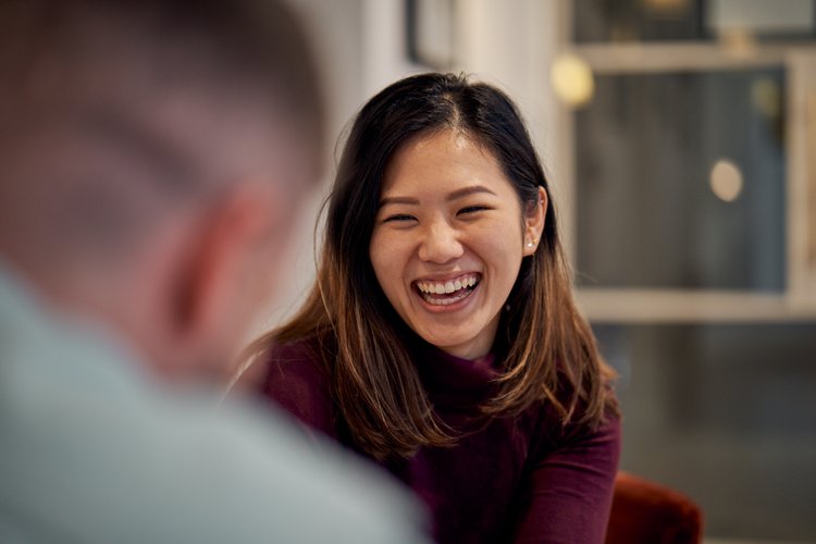 Woman laughing with colleague at TikTok