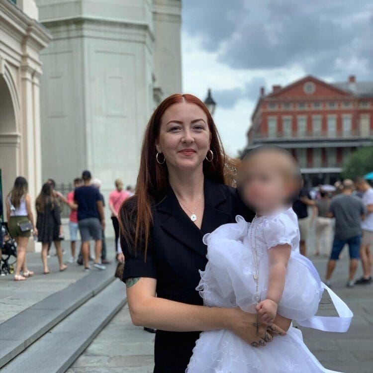 Raven Reynolds Sears holding a child