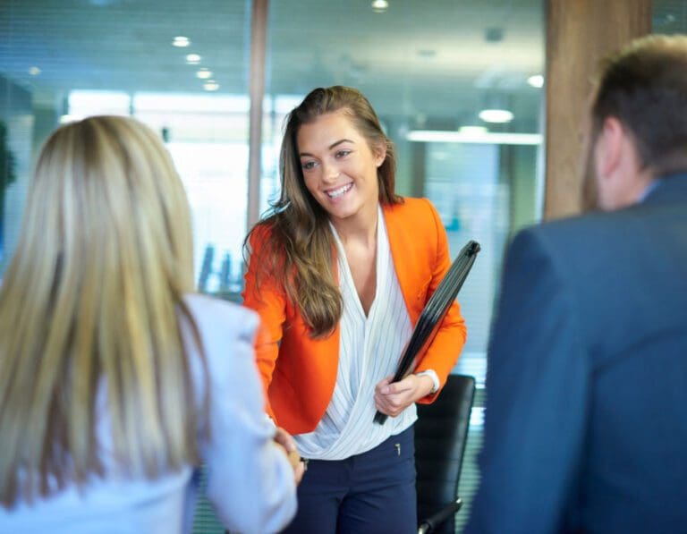 Young woman starting a new tech job meets colleagues.