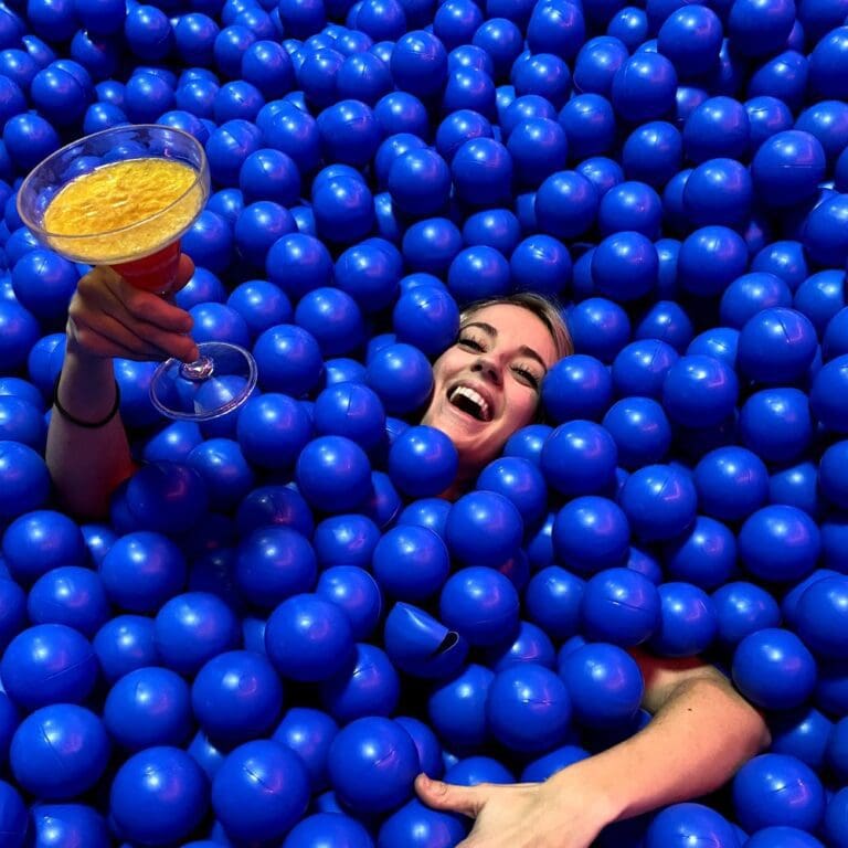 Woman playing in a ball pond.