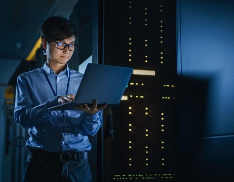 Man in server room checking cybersecurity