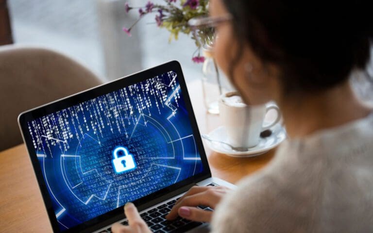 Woman in Cybersecurity, looking at a laptop screen with a padlock on it