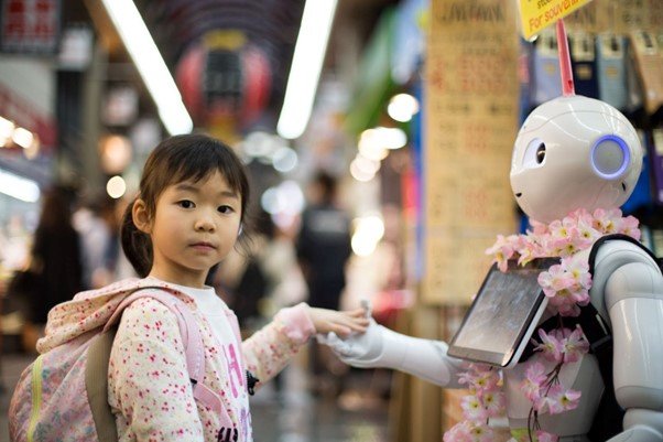 Girl encounters small friendly robot