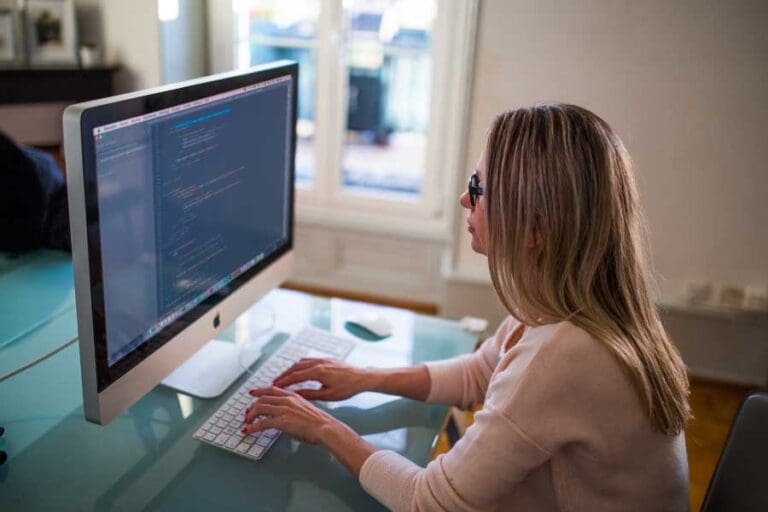 Woman coding on a Mac