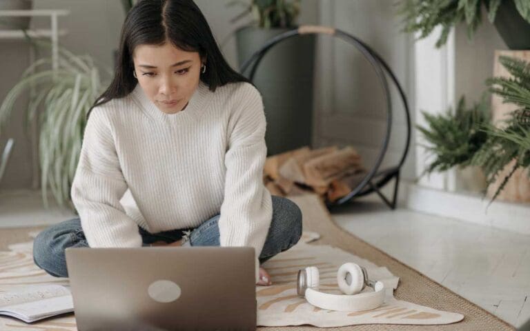 Woman working on her portfolio on a laptop