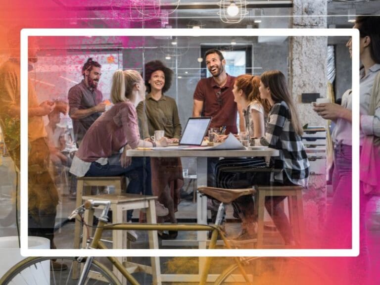 Happy freelance workers communicating while working in a corporate office