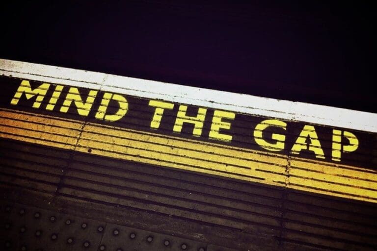 Mind+the+gap+sign+on+the+floor+of+the+London+Underground,+gender+pay+gap+concept