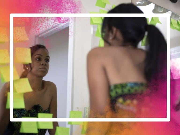 Woman looking in a mirror, imposter syndrome concept