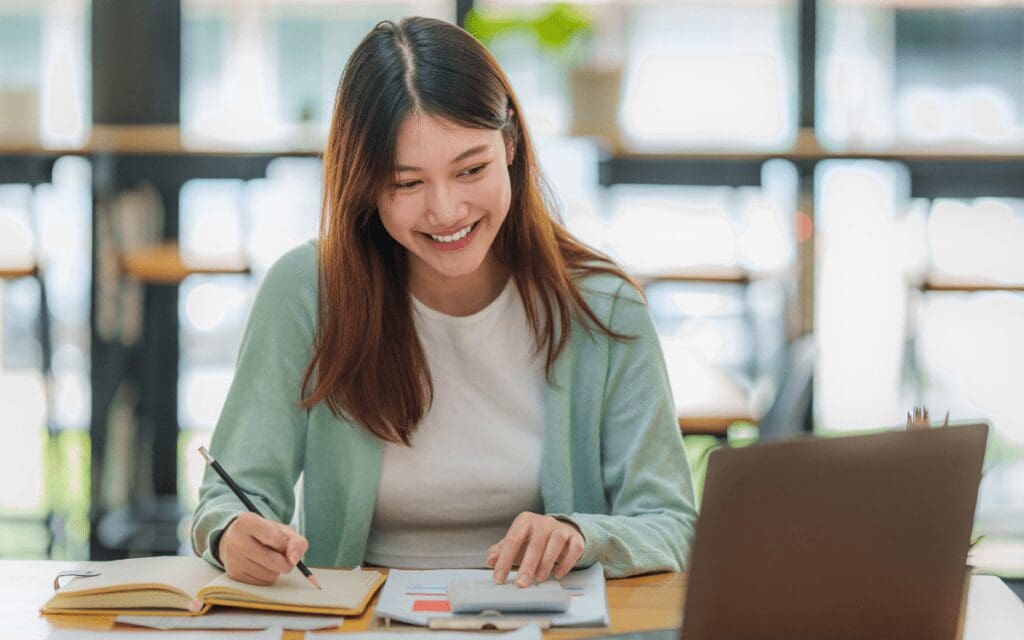 Asian woman studying from her laptop