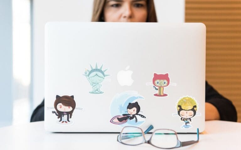 Close up of a woman working on a laptop in Github