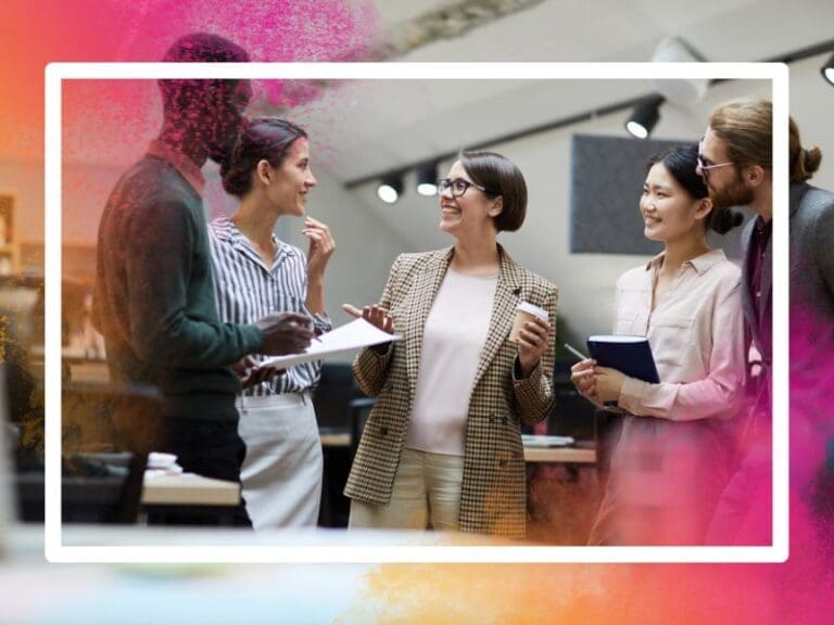 Diverse group of work colleagues chatting and smiling during a coffee break, neurodiversity openness concept