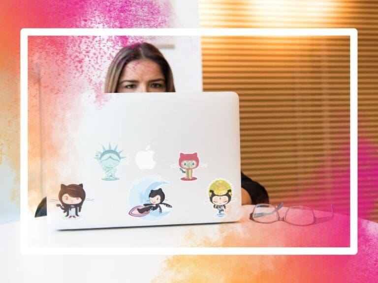 Eyeglasses in Front of Laptop Computer which has GitHub stickers on it