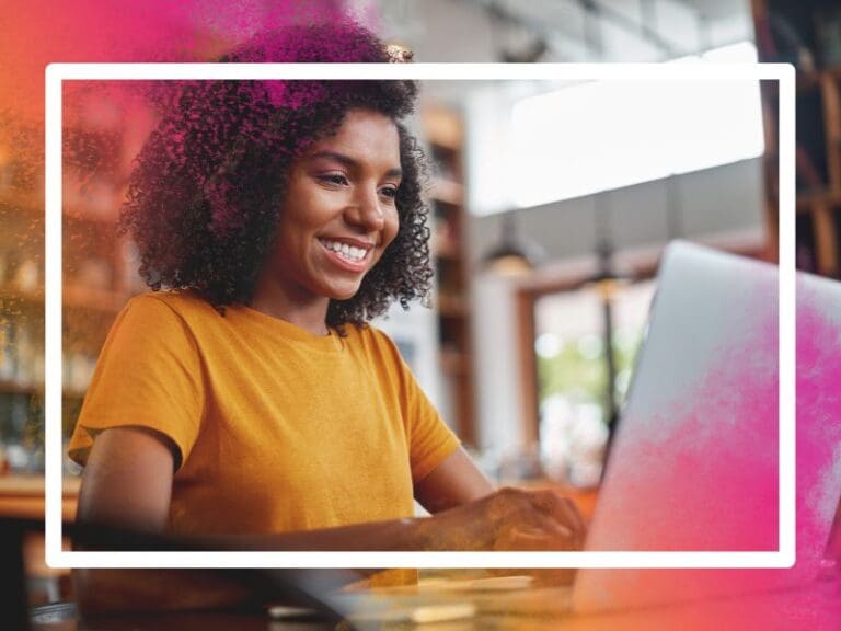 Happy young black woman using laptop in cafe, career resources
