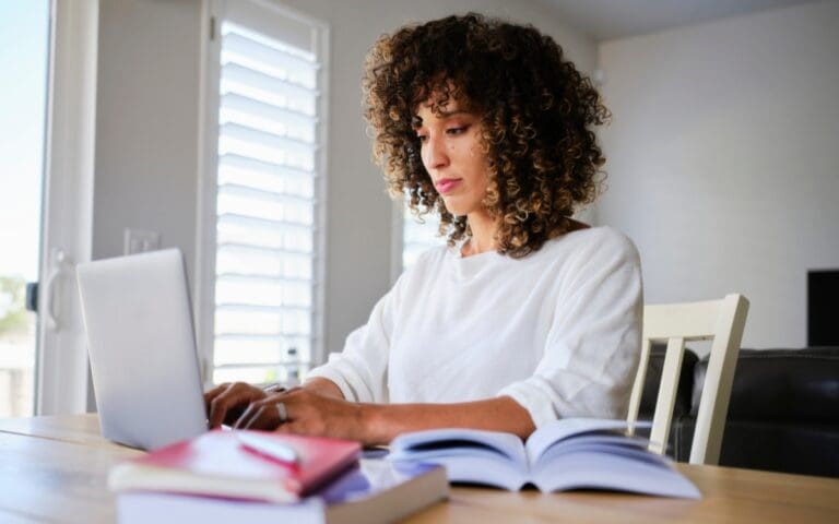 Young woman studying and learning on her computer, empowering women through learning