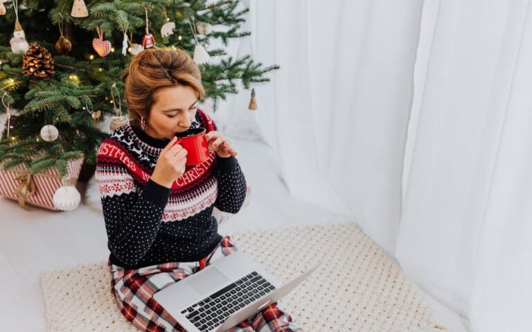 Woman working from home during festive break, wearing a Christmas jumper, Career Resolutions