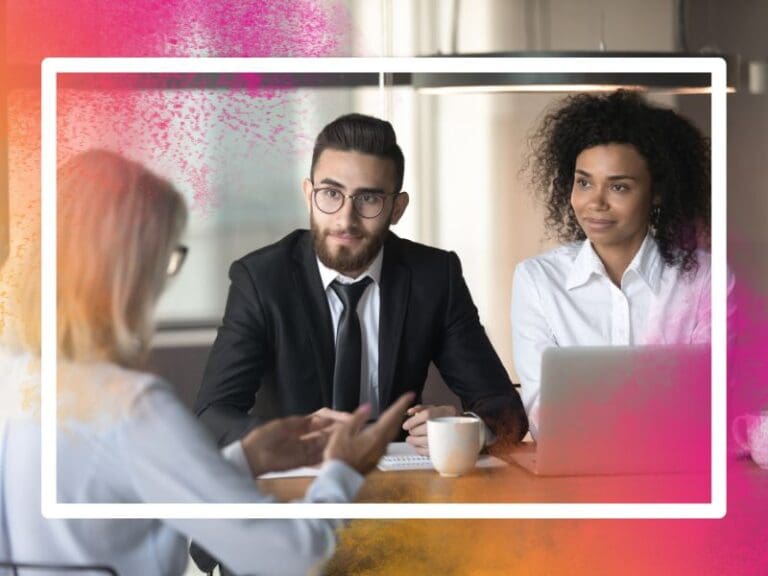Mature female mentor talking to a young intern at an office meeting, mentoring concept