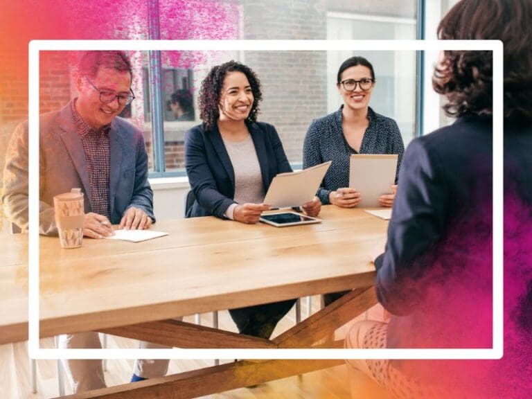 Looking at the back of a woman's head during a job interview, while 3 interviewers smile at her, Project Manager interview