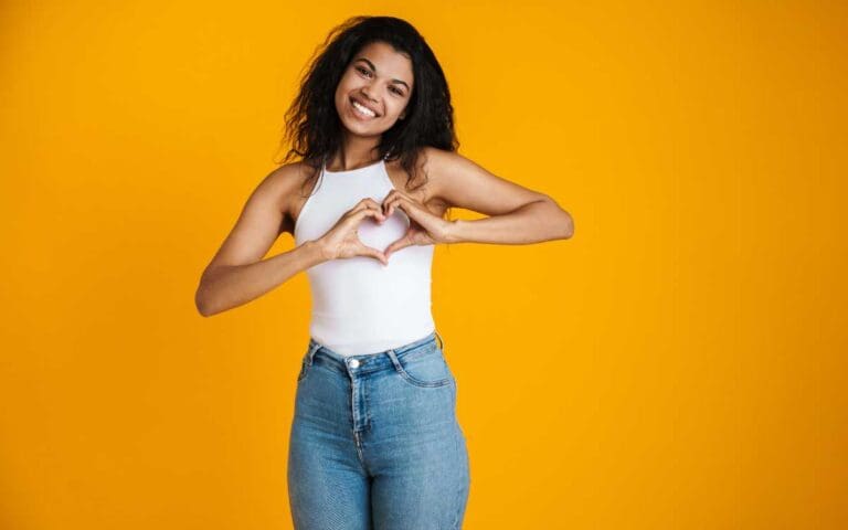 Beautiful Young Woman Making a Heart Shape Using Her Hands, International Women's Day Inspire Inclusion campaign