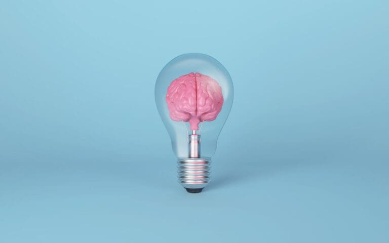 Brain on light bulb on blue background. Concept of mindset
