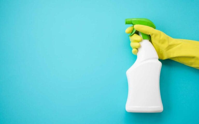Closeup of a hand holding a spray bottle of cleaning fluid, spring clean your career concept
