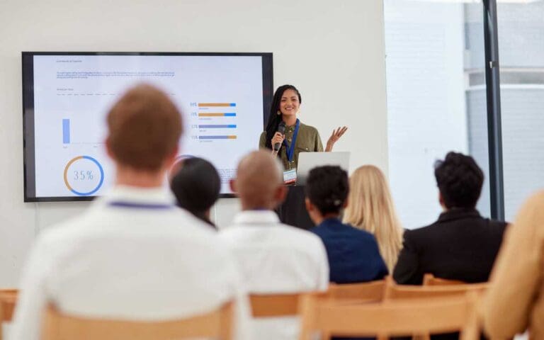 Photo of a young woman in tech delivering a presentation, soft skills