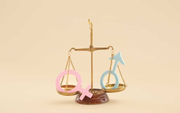 Scales with Male and Female Gender Symbols on Beige Background. Gender Disparity Concept