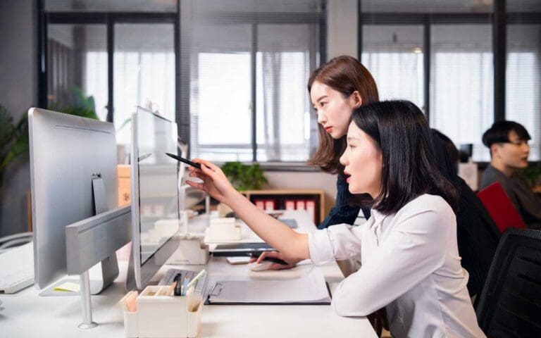 Asian women working in office, transitioning into tech concept