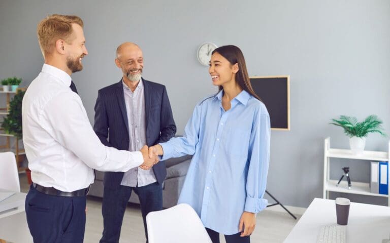 Happy Mature Company Director Introducing New Coworker to Smiling Employee in Office Workplace, sponsorship programme