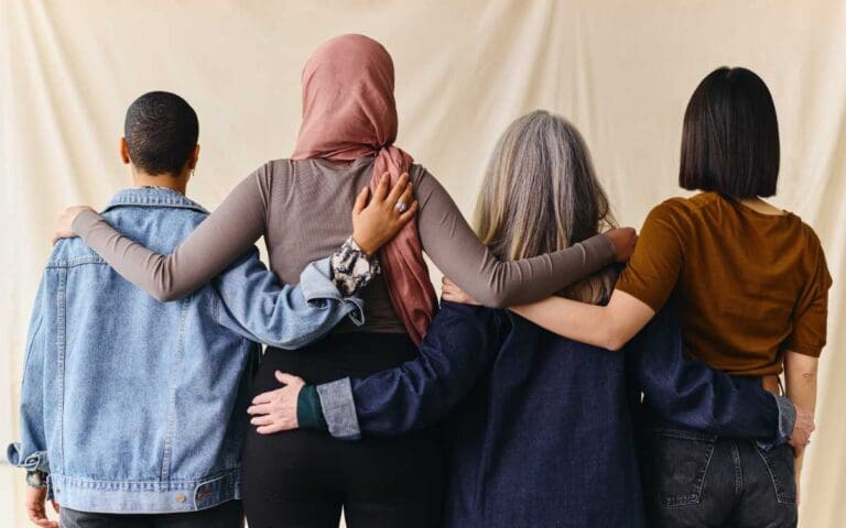 Rear View of Four Women with Arms Around Each Other, supportive women in tech networks