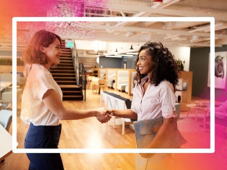 Two businesswomen shaking hands, breaking into tech concept, career transition