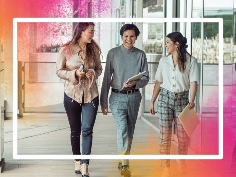 Women in tech walking with supportive colleagues