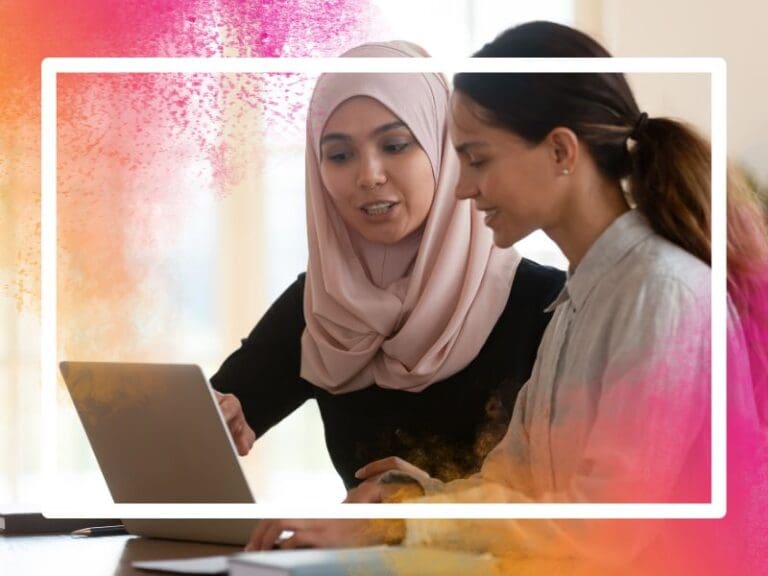 Asian muslim female mentor teaching caucasian intern explaining computer work, mentorship concept