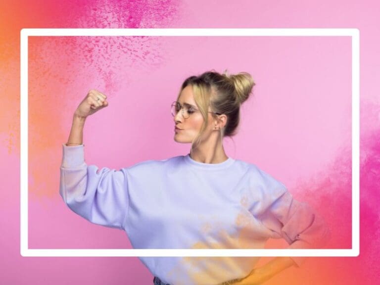 Confident, mid-adult woman flexing her muscles on a pink background, forcing change concept