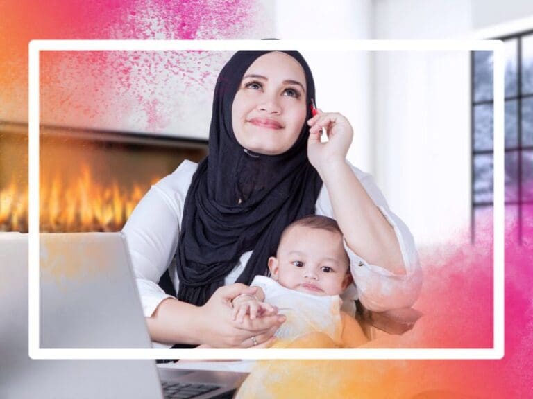 Young mum holding her baby while working at her computer, careers for mothers