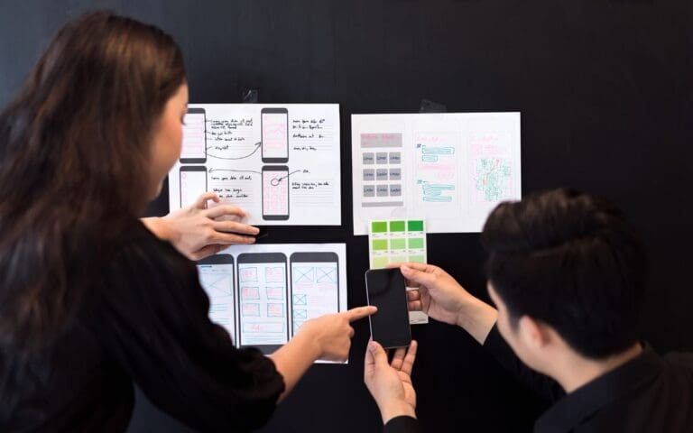 Creative ux researcher team planning application for mobile responsive website development with UIUX.