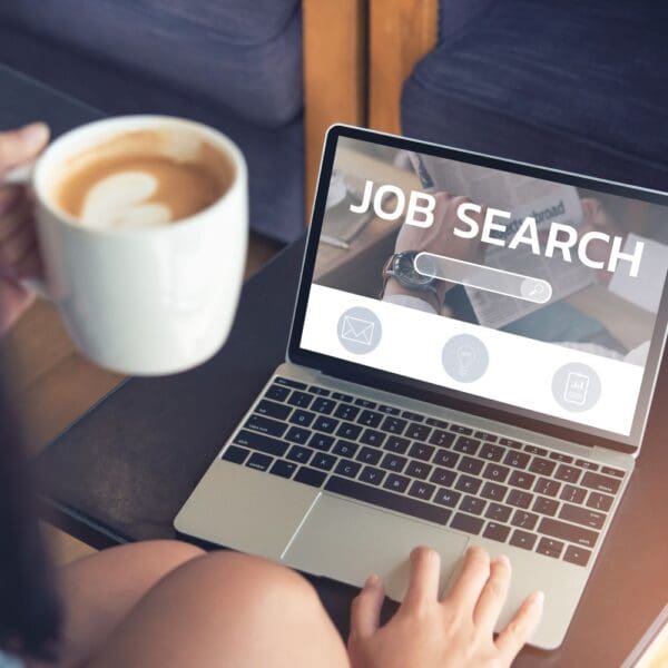 Woman searching for job posts on SheCanCode's job board