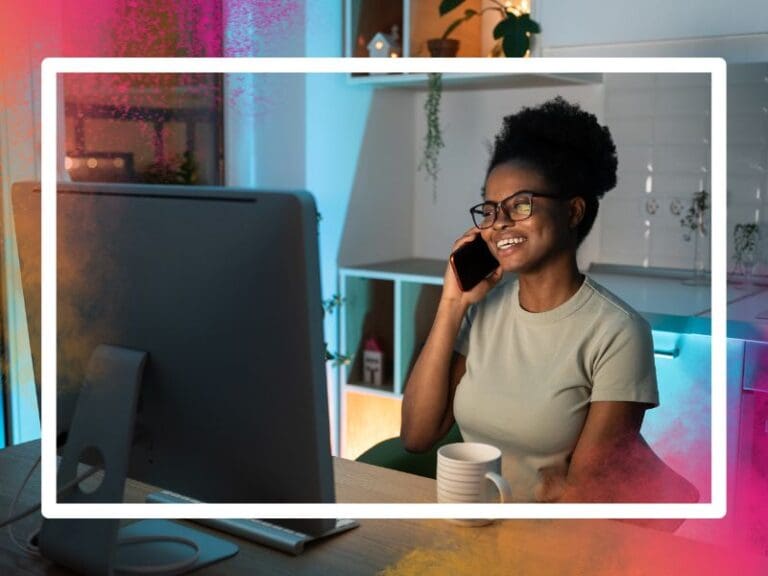 Remote female developer chatting on smartphone, enjoying flexible freelance schedule, hybrid workplace