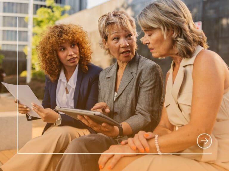 Diverse business women collaborating outdoors discussing project, HR to Tech concept